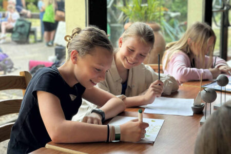 girls-drawing-and-smiling-together