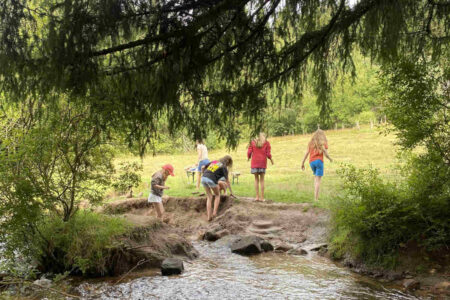 kids-climbing-the-sandbank-at-a-stream